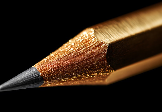 Golden pencil close-up with black background